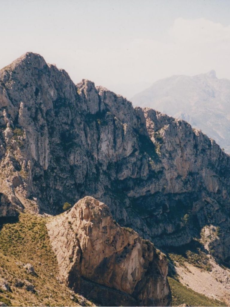 Bajando del Coll de l’Orenga, 819 mts, al fondo casi invisible la Sierra de L’Aixortà con su pico más alto Penya Alta o Cerro de Los Parados